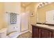 Bathroom with a walk-in shower, dark wood vanity, grey tile flooring, and a towel rack at 9519 Pearl Cir # 105, Parker, CO 80134