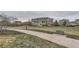 Scenic community park with a bench, paved pathway, and a view of the residential buildings at 9519 Pearl Cir # 105, Parker, CO 80134