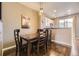 Dining area with stylish lighting and view into kitchen at 9519 Pearl Cir # 105, Parker, CO 80134