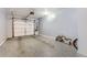 Spacious garage with epoxy floors, a white garage door, and ample storage space at 9519 Pearl Cir # 105, Parker, CO 80134