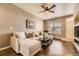 Open-concept living room with hardwood floors and abundant natural light at 9519 Pearl Cir # 105, Parker, CO 80134