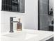 Modern bathroom featuring a stylish black faucet, white countertop, and sleek mirror at 1900 E Girard Pl # 505, Englewood, CO 80113