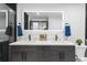 Elegant bathroom featuring double sinks, dark cabinets, and a well-lit mirror at 1900 E Girard Pl # 505, Englewood, CO 80113