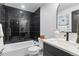 Modern bathroom features dark tiled walls surrounding the tub, and a sleek vanity with a vessel sink at 1900 E Girard Pl # 505, Englewood, CO 80113