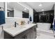Bright bathroom featuring double sinks, a large mirror, and a soaking tub at 1900 E Girard Pl # 505, Englewood, CO 80113