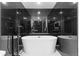 Modern bathroom featuring a soaking tub and dark tile backsplash at 1900 E Girard Pl # 505, Englewood, CO 80113