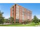 View of a tall brick building with lots of windows and greenery at 1900 E Girard Pl # 505, Englewood, CO 80113