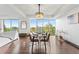 Elegant dining room with hardwood floors, a chandelier, and large windows offering scenic views at 1900 E Girard Pl # 505, Englewood, CO 80113