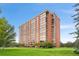 Brick high-rise apartment building featuring manicured lawn at 1900 E Girard Pl # 505, Englewood, CO 80113