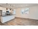 Bright kitchen with a center island, modern appliances, sleek countertops, and ample natural light at 2484 W 69Th Pl, Denver, CO 80221