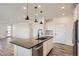 Stylish kitchen featuring a large island, stainless steel appliances, and open layout to the living area at 2484 W 69Th Pl, Denver, CO 80221