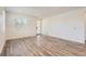 Bright living room with hardwood floors, recessed lighting, a modern door, and ample natural light at 2484 W 69Th Pl, Denver, CO 80221