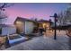 Beautiful backyard with a stone patio, garden boxes, and outdoor kitchen space at 4063 S Quintero Way, Aurora, CO 80013