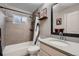 The bathroom includes tiled walls and a shower, a dark-framed mirror, and a shower shelf at 4063 S Quintero Way, Aurora, CO 80013