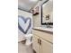 Bathroom features a gray heart shower curtain, black framed mirror, and modern vanity at 4063 S Quintero Way, Aurora, CO 80013
