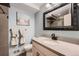 Beautifully updated bathroom with modern vanity, new fixtures, and decorative accents at 4063 S Quintero Way, Aurora, CO 80013