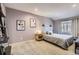 Comfortable bedroom shows calming decor, with a headboard-mounted lamp, carpet, and window at 4063 S Quintero Way, Aurora, CO 80013