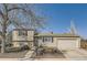 Classic two-story home with a well-kept lawn, mature trees, and an attached garage at 4063 S Quintero Way, Aurora, CO 80013