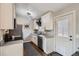 Updated kitchen featuring white cabinets, stainless steel appliances, and gray countertops at 4063 S Quintero Way, Aurora, CO 80013