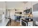 Bright and spacious kitchen with white cabinets, stainless steel appliances, and a wet bar for entertaining at 4063 S Quintero Way, Aurora, CO 80013