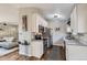 Modern kitchen with stainless steel appliances, white cabinets, and sleek countertops at 4063 S Quintero Way, Aurora, CO 80013