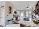 Cozy kitchenette featuring barstool seating, modern fixtures, and a seamless transition to the kitchen area at 4063 S Quintero Way, Aurora, CO 80013