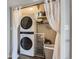 Convenient laundry area with a stackable washer and dryer and shelving for storage at 4063 S Quintero Way, Aurora, CO 80013