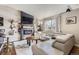 Comfortable living room featuring a modern fireplace, flat screen TV, and light gray leather sectional sofa at 4063 S Quintero Way, Aurora, CO 80013