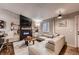 Welcoming living room with a modern fireplace, flat screen TV, and comfortable sectional sofa at 4063 S Quintero Way, Aurora, CO 80013