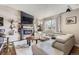Modern living room featuring a sleek fireplace, stylish shelving, and comfortable leather couch at 4063 S Quintero Way, Aurora, CO 80013
