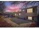 Home with a large backyard, patio, and peaceful surroundings against a vibrant evening sky at 4063 S Quintero Way, Aurora, CO 80013