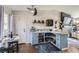 Stylish wet bar with custom cabinets, wine storage, beverage refrigerator, and seating area for entertaining at 4063 S Quintero Way, Aurora, CO 80013