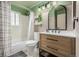 Bright bathroom featuring a tub, shower, wood vanity, and decorative mirror at 16051 E Alabama Dr, Aurora, CO 80017