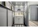 Powder bathroom featuring gray paneled walls, elegant fixtures, and gold accented decor at 16051 E Alabama Dr, Aurora, CO 80017