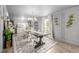 Elegant dining room featuring a large table, chandelier, and modern decor at 16051 E Alabama Dr, Aurora, CO 80017
