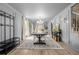 Spacious dining room featuring modern lighting, wainscotting and stairs at 16051 E Alabama Dr, Aurora, CO 80017