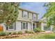 Charming two-story home featuring a well-maintained lawn and attractive landscaping at 16051 E Alabama Dr, Aurora, CO 80017