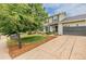 Two-story home showcasing a well-manicured lawn, driveway, and charming curb appeal at 16051 E Alabama Dr, Aurora, CO 80017