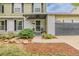 Charming home exterior with well-maintained landscaping, walkway, and an attached garage at 16051 E Alabama Dr, Aurora, CO 80017