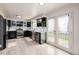Stylish kitchen with stainless steel appliances, black cabinets and glass door to back yard at 16051 E Alabama Dr, Aurora, CO 80017