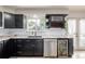 Modern kitchen featuring dark cabinetry, granite countertops, stainless steel appliances, and a wine storage rack at 16051 E Alabama Dr, Aurora, CO 80017