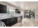 Bright kitchen showcasing dark cabinetry, granite countertops, stainless steel appliances and light wood flooring at 16051 E Alabama Dr, Aurora, CO 80017