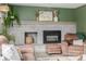 Inviting living room featuring a painted brick fireplace and comfortable seating at 16051 E Alabama Dr, Aurora, CO 80017