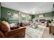 Inviting living room featuring a cozy fireplace, plush seating, and stylish decor at 16051 E Alabama Dr, Aurora, CO 80017