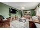 Cozy living room features olive green walls, a stylish rug, and comfortable seating at 16051 E Alabama Dr, Aurora, CO 80017