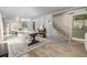 Open-concept living room with dining area, staircase, and neutral decor at 16051 E Alabama Dr, Aurora, CO 80017