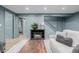 View of the living room with a wooden table, an electric fireplace, and access to the stairs at 16051 E Alabama Dr, Aurora, CO 80017
