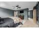 Bedroom with built-in features, a decorative fireplace, paneled walls, and neutral carpet at 16051 E Alabama Dr, Aurora, CO 80017