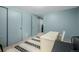 Well-lit office featuring a white desk, chair, and a patterned rug at 16051 E Alabama Dr, Aurora, CO 80017