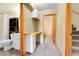 Bathroom with built in shelves and a toilet with white cabinetry below a countertop sink and wooden framed mirrors at 30273 Conifer Rd, Evergreen, CO 80439